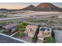 Aerial view of desert homes showcasing tiled roofs and community landscaping near natural desert landscape at 32359 N 129Th Dr, Peoria, AZ 85383