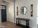 Bright foyer featuring modern decor, wood-look floors, and a stylish front door with glass accents at 3765 N Denny Way, Buckeye, AZ 85396