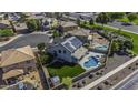 Aerial view of a home featuring a private pool, green lawn, solar panels, and landscaped backyard at 41581 W Somerset Dr, Maricopa, AZ 85138