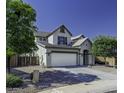 Charming two-story home featuring a large two-car garage and a low maintenance landscaped front yard at 41581 W Somerset Dr, Maricopa, AZ 85138
