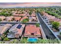 A high-angle view captures a home with a pool and solar panels in a suburban community at 4208 E Hamblin Dr, Phoenix, AZ 85050