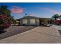Cozy home featuring a carport and covered patio, surrounded by desert landscaping for easy maintenance at 427 S 80Th Way, Mesa, AZ 85208
