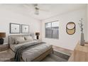 Cozy bedroom features a queen size bed, neutral colors, large window, and plush carpeting at 4406 E Carter Dr, Phoenix, AZ 85042