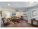 Inviting living room with wood floors, neutral walls, plantation shutters, and comfortable seating at 520 S Greenfield Rd # 7, Mesa, AZ 85206