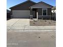 Charming single-story home featuring a two-car garage, neutral stucco, and decorative stone accents enhancing curb appeal at 5722 E Iris Dr, Florence, AZ 85132