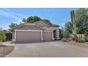 Charming single-story home with desert landscaping and a spacious three-car garage at 5733 E Jaeger St, Mesa, AZ 85205
