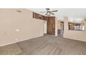 Spacious living room featuring neutral carpet and unique wood accent wall at 5733 E Jaeger St, Mesa, AZ 85205