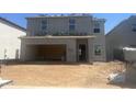 Exterior view of a two-story home under construction, showing the garage, yard, and unfinished details at 5846 S 242Nd Ln, Buckeye, AZ 85326