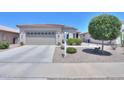 Charming single-story home with tile roof, desert landscaping, and a two-car garage at 60 S Agua Fria Ln, Casa Grande, AZ 85194