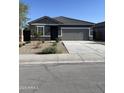 Well-maintained single-story home with a two-car garage and a gray exterior paint at 6113 E Artemis Dr, Florence, AZ 85132