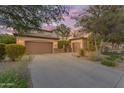 Spacious home featuring a three-car garage, desert landscaping, and a large driveway at 824 W Whitten St, Chandler, AZ 85225