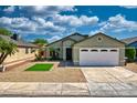 Charming single-story home offers desert landscaping, a patch of green turf, and a convenient two-car garage at 8501 W Highland Ave, Phoenix, AZ 85037