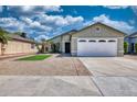 Lovely single-story home features a well-kept yard with desert landscaping, vibrant turf, and a convenient two-car garage at 8501 W Highland Ave, Phoenix, AZ 85037