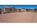 Quaint single-level house with a spacious front yard and traditional architecture at 8818 W Pinchot Ave, Phoenix, AZ 85037