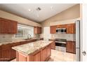 Well-lit kitchen featuring granite countertops, a kitchen island and modern appliances, offering both style and functionality at 882 N Concord Ave, Chandler, AZ 85225