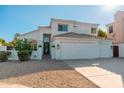 Inviting stucco home featuring a tile roof, desert landscaping, and a two-car garage at 13 W Silverwood Dr, Phoenix, AZ 85045