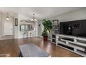 Open-concept living room features stylish furnishings and hardwood flooring with ample natural light at 13373 W Boca Raton Rd, Surprise, AZ 85379