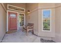Welcoming front porch with a cozy bench, stylish front door, and views of the well-manicured yard at 14609 S 24Th Way, Phoenix, AZ 85048