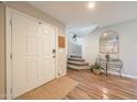 Bright foyer with hardwood floors, a staircase, and a stylish table with decor at 14770 W Columbine Dr, Surprise, AZ 85379