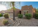 Attractive single-story home with desert landscaping, a two-car garage, and an inviting facade at 15674 W Mackenzie Dr, Goodyear, AZ 85395