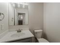 View of half-bath including a white commode and single-sink vanity at 1671 E Silktassel Trl, San Tan Valley, AZ 85143