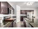 Well-equipped kitchen featuring dark cabinets, stainless appliances, and granite countertops at 21014 W Ridge Rd, Buckeye, AZ 85396