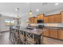Spacious eat-in kitchen with a large island, modern appliances, and natural light at 23886 W Harrison Dr, Buckeye, AZ 85326