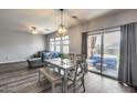 Bright dining area with wood floors, stylish light fixture and view of the backyard at 2531 W Saint Catherine Ave, Phoenix, AZ 85041