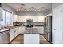 Modern kitchen features white cabinetry, stainless appliances, and an island at 2531 W Saint Catherine Ave, Phoenix, AZ 85041