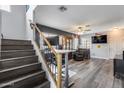 Inviting living room with wood floors and open floor plan, connected to staircase at 2531 W Saint Catherine Ave, Phoenix, AZ 85041