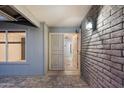 Welcoming covered entryway with brick accents and decorative security door at 2726 W Meseto Cir, Mesa, AZ 85202