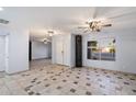 Bright living room with neutral tile flooring, a ceiling fan, and large windows at 2726 W Meseto Cir, Mesa, AZ 85202