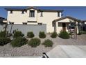 Two story home featuring neutral stucco and a red-tile roof with well-kept landscaping in a suburban neighborhood at 3363 S 180Th Ln, Goodyear, AZ 85338