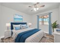 Bedroom featuring neutral walls, wood-look flooring, ceiling fan, and a sliding glass door at 3444 E Paradise Dr, Phoenix, AZ 85028