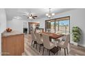 Spacious dining area featuring modern lighting and direct access to outdoor patio and pool at 3444 E Paradise Dr, Phoenix, AZ 85028