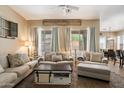 Spacious living room featuring multiple couches, a ceiling fan, and decorative elements at 35414 N 32Nd Dr, Phoenix, AZ 85086