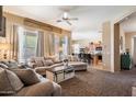 Bright and airy living room open to the kitchen with modern furniture and neutral decor at 35414 N 32Nd Dr, Phoenix, AZ 85086