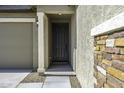 Inviting front entrance featuring a stylish door, stone accents, and a welcoming porch, creating a great first impression at 36602 W San Alvarez Ave, Maricopa, AZ 85138