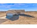 Single-Gathering home featuring a two-car garage, desert landscaping, and neutral stucco at 37504 W Elm Ave, Tonopah, AZ 85354