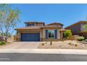 Inviting two-story home with a blue garage door, desert landscaping, and a tile roof at 3804 E Daley Ln, Phoenix, AZ 85050