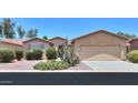 Desert landscape in the front yard, complemented by a neutral exterior paint and a two car garage at 42360 W Abbey Rd, Maricopa, AZ 85138