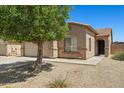 A well-kept home with desert landscaping and a mature shade tree in the front yard at 43938 W Colby Dr, Maricopa, AZ 85138