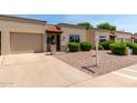 Charming single-story home boasts a desert landscape, attached garage and a well-manicured lawn at 4502 E Carol Ave # 4, Mesa, AZ 85206