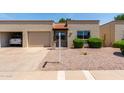 Inviting single-story home boasts well-kept landscaping, an attached garage and a welcoming entrance at 4502 E Carol Ave # 4, Mesa, AZ 85206