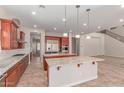 A wide-open kitchen showcases granite countertops, modern appliances, and seamless access to the adjacent living spaces at 4724 S Anitole Way, Mesa, AZ 85212