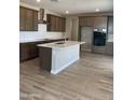 Spacious kitchen features a central island, stainless steel appliances, and ample cabinet space at 4930 W Brown St, Glendale, AZ 85302