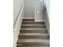 Carpeted staircase with white railing leading to the upper level at 5004 W Brown St, Glendale, AZ 85302