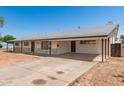 Charming single-story home featuring a covered carport, stone accents and a long driveway at 501 W Dublin St, Chandler, AZ 85225