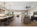 Open-concept living area with kitchen island, dining area, and comfortable seating at 5724 E Scarlet St, Mesa, AZ 85215