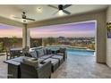 Relaxing covered patio featuring a ceiling fan, outdoor seating, and a beautiful view of the pool at 5724 E Scarlet St, Mesa, AZ 85215